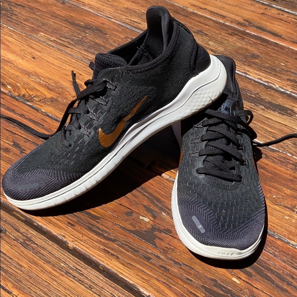 Nike sneakers with gold swoosh